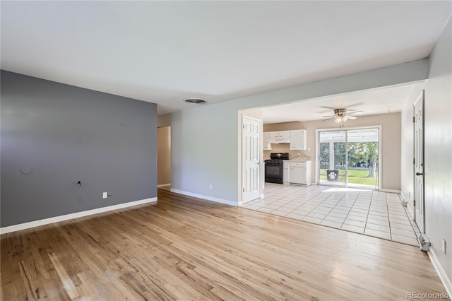 unfurnished living room featuring light wood-type flooring and ceiling fan