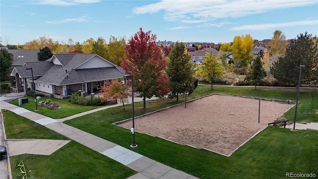 view of home's community featuring a lawn and volleyball court