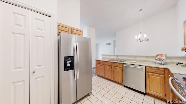 kitchen featuring sink, light tile patterned flooring, pendant lighting, an inviting chandelier, and appliances with stainless steel finishes