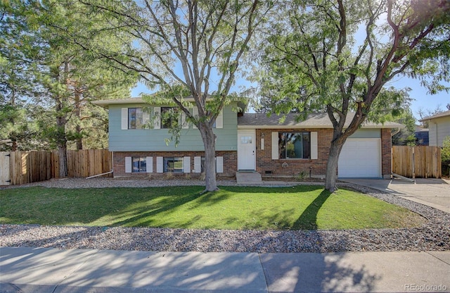 tri-level home featuring a garage and a front lawn