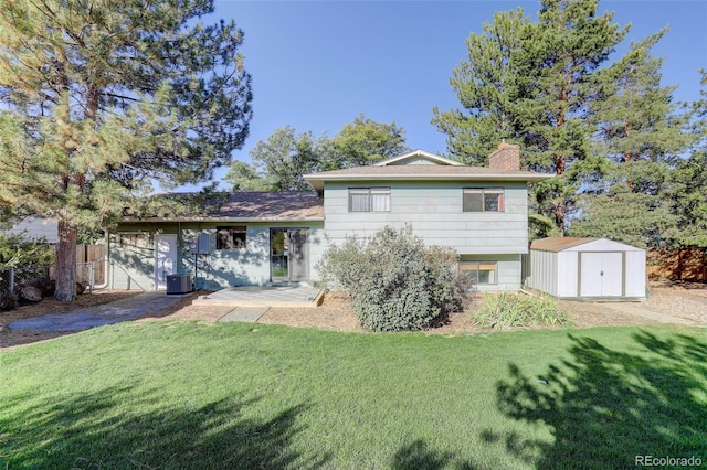 back of house with cooling unit, a storage shed, a yard, and a patio area