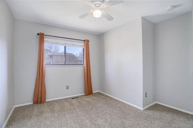 empty room with ceiling fan and carpet floors