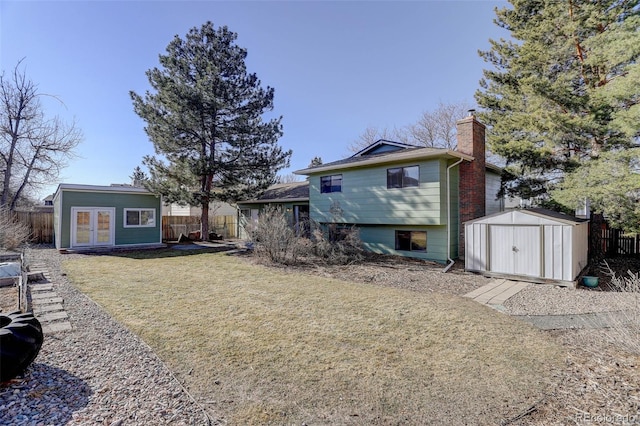 back of property with a lawn and a storage unit