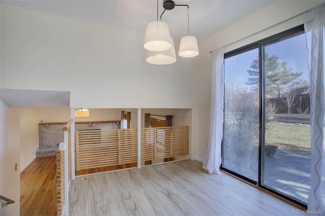 unfurnished dining area with light wood-type flooring