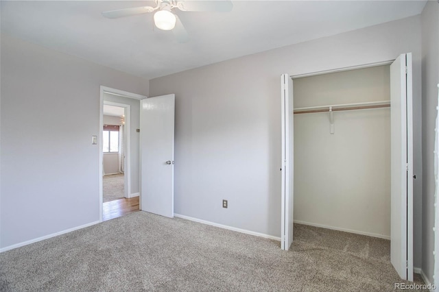 unfurnished bedroom with carpet floors, ceiling fan, and a closet