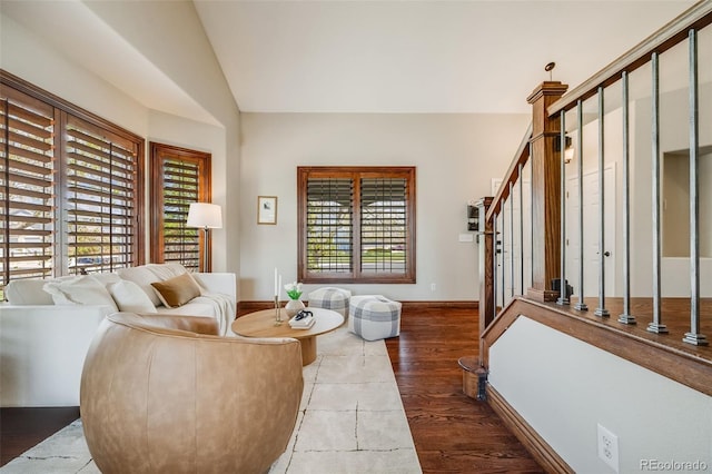 17522 E Dewberry Dr, Parker, CO 80134 - living area with vaulted ceiling, wood finished floors, baseboards, and stairway