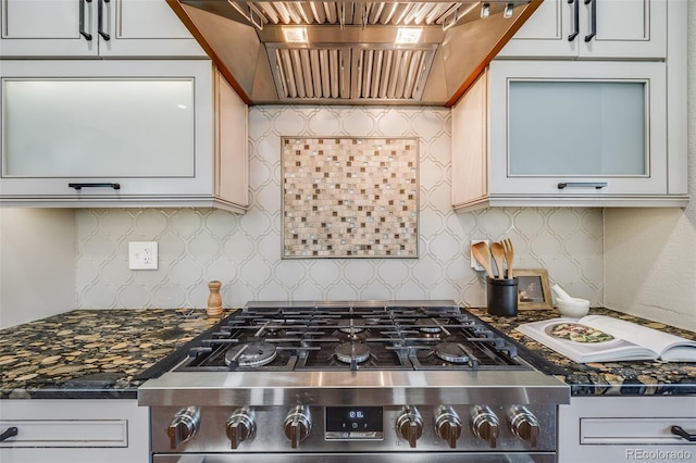 17522 E Dewberry Dr, Parker, CO 80134 - kitchen with custom range hood, backsplash, gas stove, dark stone counters, and white cabinets