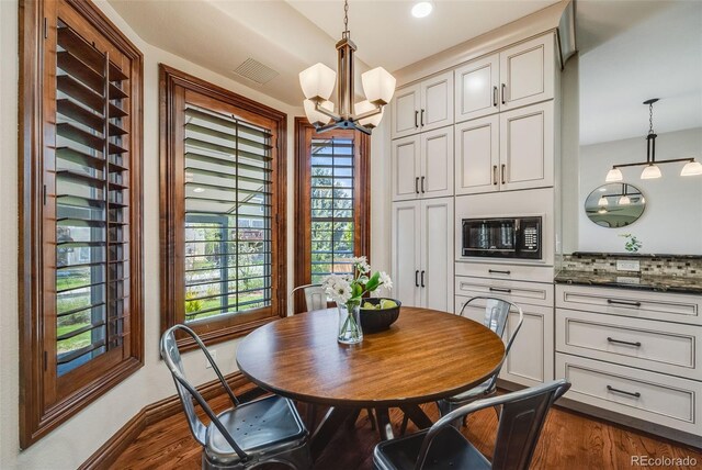 17522 E Dewberry Dr, Parker, CO 80134 - dining room with a chandelier, dark wood-style floors, plenty of natural light, and baseboards