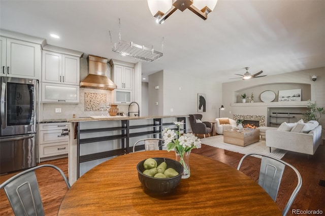 17522 E Dewberry Dr, Parker, CO 80134 - dining area with ceiling fan, wood finished floors, a lit fireplace, and recessed lighting