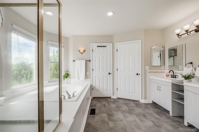 17522 E Dewberry Dr, Parker, CO 80134 - bathroom featuring vanity, a bath, recessed lighting, and an enclosed shower