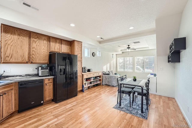 kitchen with ceiling fan, black appliances, a textured ceiling, and light wood-type flooring