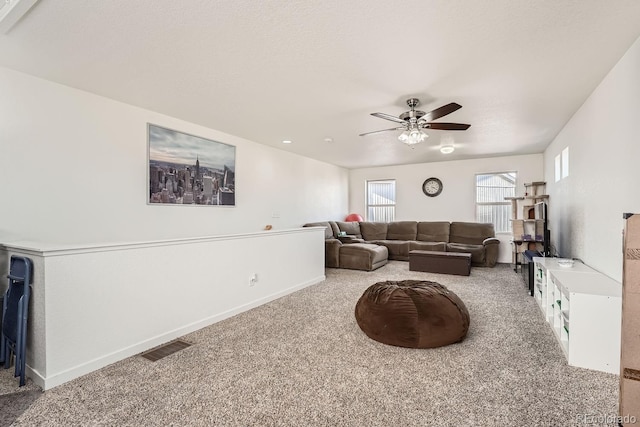 carpeted living room featuring ceiling fan