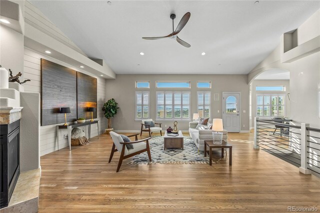 3485 Park Ridge Rd, Sedalia, CO 80135 - living area featuring a fireplace, a ceiling fan, vaulted ceiling, light wood-type flooring, and recessed lighting
