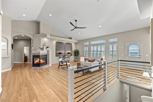 3485 Park Ridge Rd, Sedalia, CO 80135 - living room with ceiling fan, wood finished floors, a multi sided fireplace, arched walkways, and recessed lighting