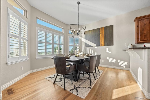 3485 Park Ridge Rd, Sedalia, CO 80135 - dining space with a chandelier, light wood-style floors, and baseboards