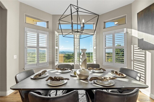 3485 Park Ridge Rd, Sedalia, CO 80135 - dining room featuring a chandelier, plenty of natural light, and wood finished floors