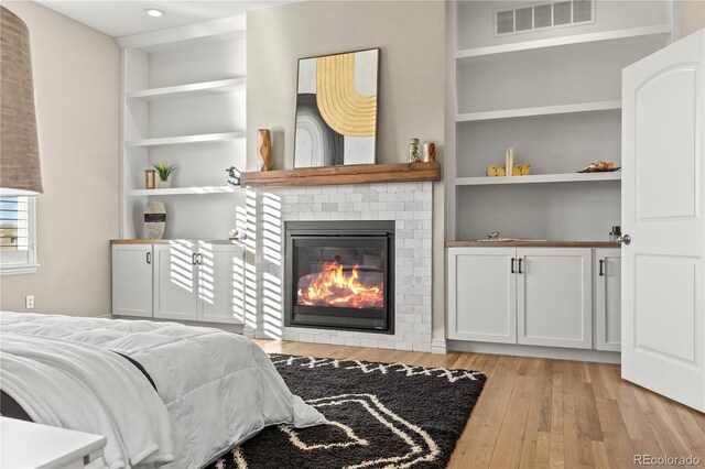 3485 Park Ridge Rd, Sedalia, CO 80135 - bedroom with light wood-style floors, a fireplace, and recessed lighting