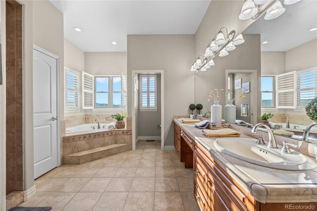 3485 Park Ridge Rd, Sedalia, CO 80135 - bathroom featuring double vanity, a garden tub, baseboards, and a shower