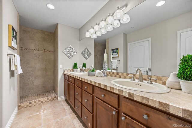 3485 Park Ridge Rd, Sedalia, CO 80135 - bathroom featuring double vanity, walk in shower, baseboards, tile patterned flooring, and recessed lighting