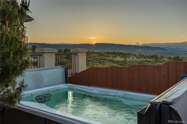 3485 Park Ridge Rd, Sedalia, CO 80135 - pool at dusk featuring a mountain view and a hot tub