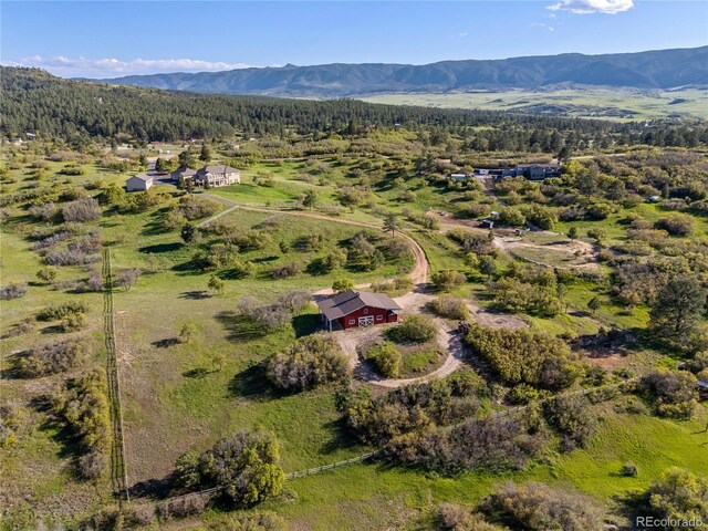 3485 Park Ridge Rd, Sedalia, CO 80135 - aerial overview of property's location featuring a heavily wooded area and a mountain backdrop