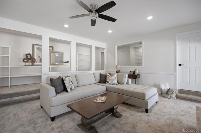 carpeted living room featuring built in features and ceiling fan