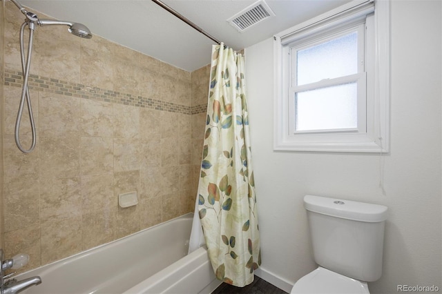 bathroom with toilet and shower / bathtub combination with curtain