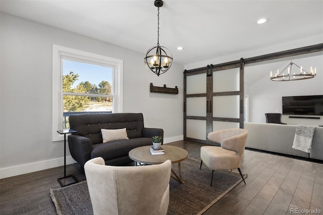 living area featuring a barn door, wood finished floors, baseboards, an inviting chandelier, and recessed lighting