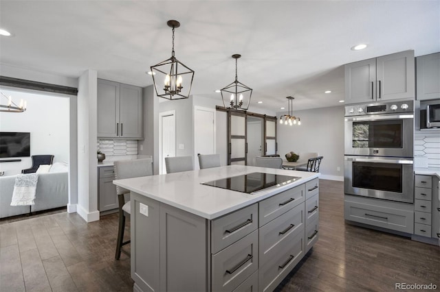 kitchen featuring an inviting chandelier, gray cabinets, and stainless steel appliances