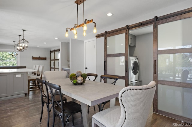 dining space with recessed lighting, washer / clothes dryer, dark wood-style floors, and a barn door