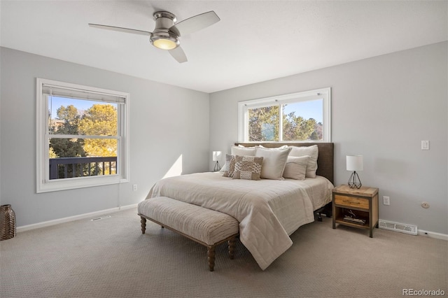 carpeted bedroom with visible vents, a ceiling fan, and baseboards