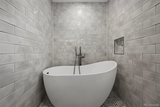 full bath with tile walls, a soaking tub, and tile patterned floors