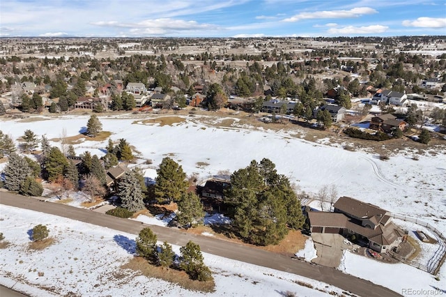 snowy aerial view with a residential view