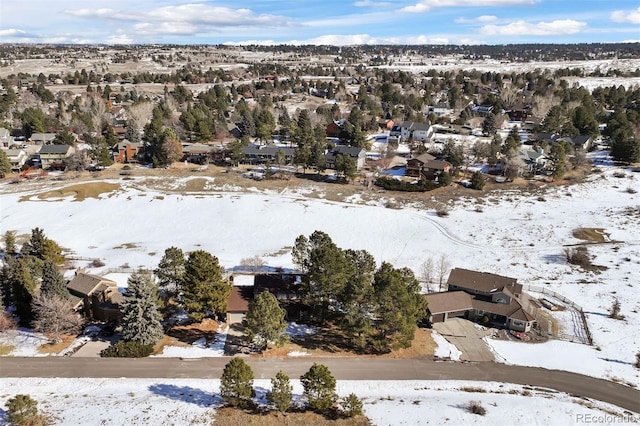 snowy aerial view with a residential view