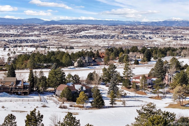 snowy aerial view with a residential view and a mountain view