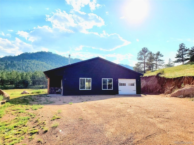 45 Saltlick Cir, Florissant, CO 80816 - garage featuring dirt driveway and a mountain view