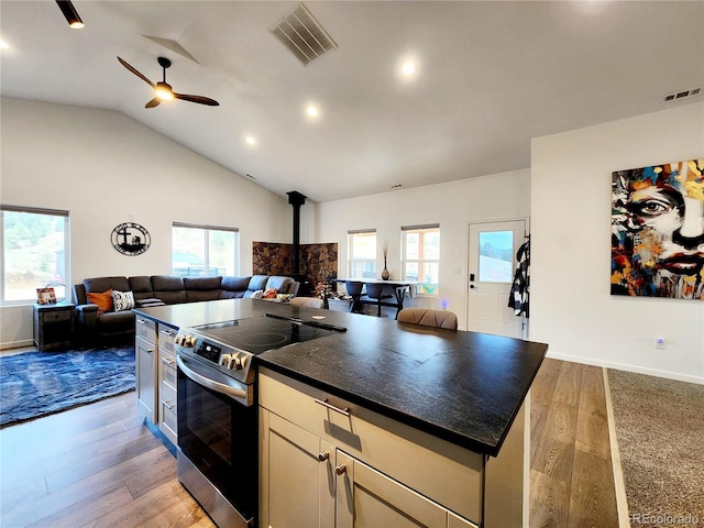 45 Saltlick Cir, Florissant, CO 80816 - kitchen with open floor plan, a wood stove, visible vents, and electric stove