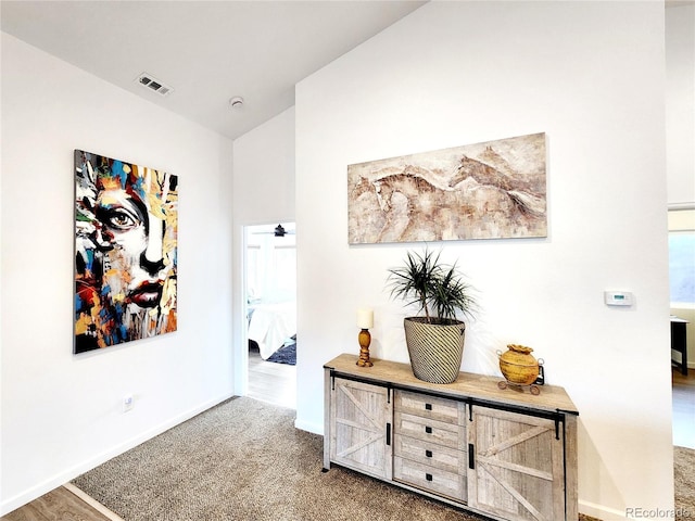 45 Saltlick Cir, Florissant, CO 80816 - hallway featuring lofted ceiling, visible vents, carpet flooring, and baseboards
