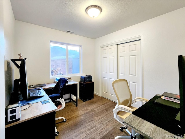 45 Saltlick Cir, Florissant, CO 80816 - office space featuring a textured ceiling, wood finished floors, and visible vents