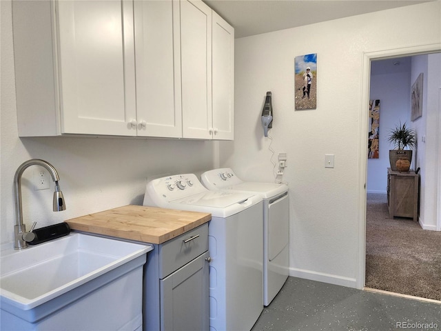 45 Saltlick Cir, Florissant, CO 80816 - laundry area featuring washer and clothes dryer, baseboards, a sink, and cabinet space