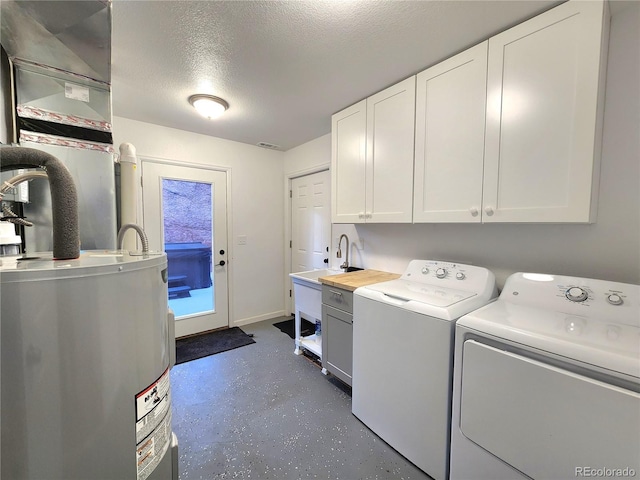 45 Saltlick Cir, Florissant, CO 80816 - clothes washing area with a sink, a textured ceiling, electric water heater, washer and dryer, and cabinet space