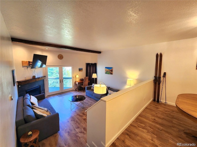 154 Fawn Ct, Silverthorne, CO 80443 - living room with a textured ceiling, wood finished floors, french doors, a fireplace, and baseboards