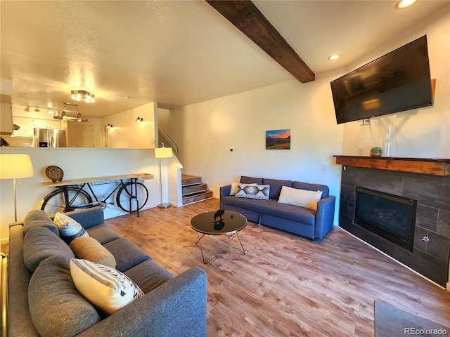 154 Fawn Ct, Silverthorne, CO 80443 - living room with wood finished floors, stairway, a tile fireplace, recessed lighting, and beamed ceiling