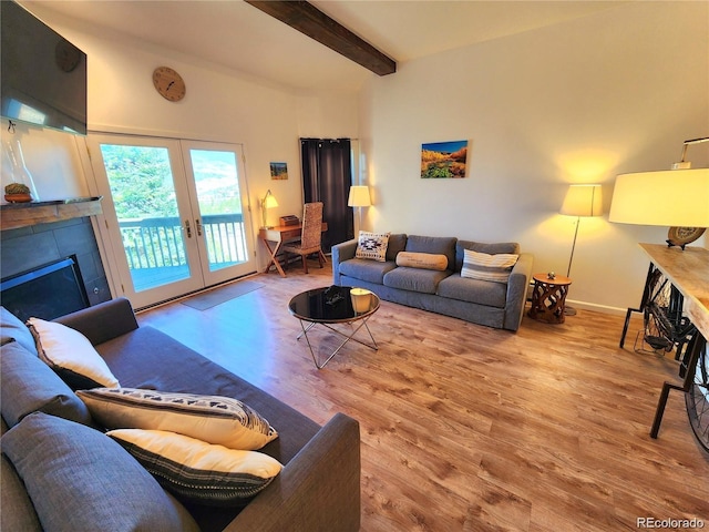 154 Fawn Ct, Silverthorne, CO 80443 - living area featuring wood finished floors, beam ceiling, a fireplace, french doors, and baseboards