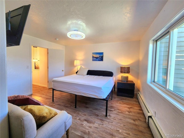 154 Fawn Ct, Silverthorne, CO 80443 - bedroom featuring wood finished floors, a textured ceiling, and baseboards
