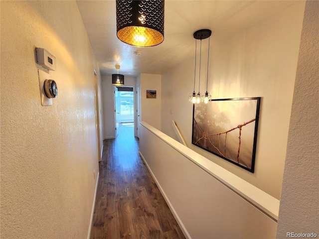 154 Fawn Ct, Silverthorne, CO 80443 - hallway featuring wood finished floors, a textured wall, and baseboards