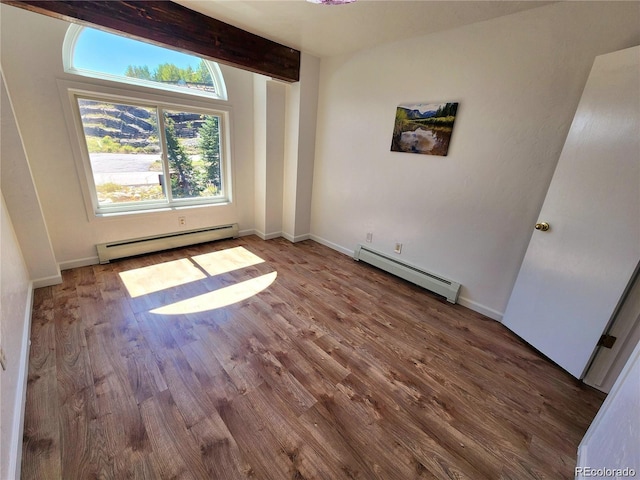 154 Fawn Ct, Silverthorne, CO 80443 - unfurnished room with a baseboard heating unit, wood finished floors, baseboards, and beamed ceiling