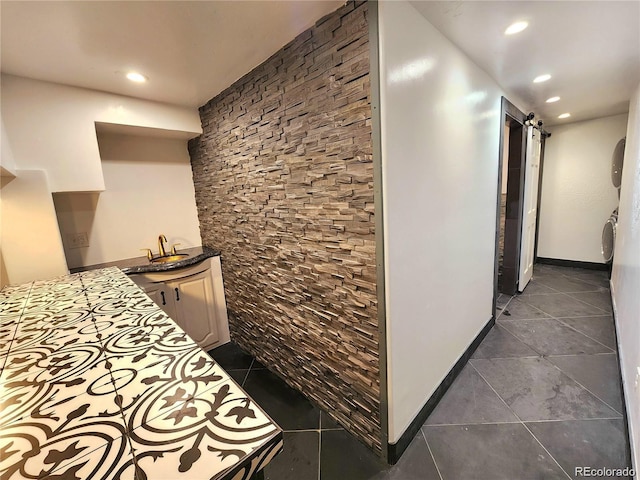 154 Fawn Ct, Silverthorne, CO 80443 - corridor with a barn door, dark tile patterned floors, recessed lighting, baseboards, and a sink