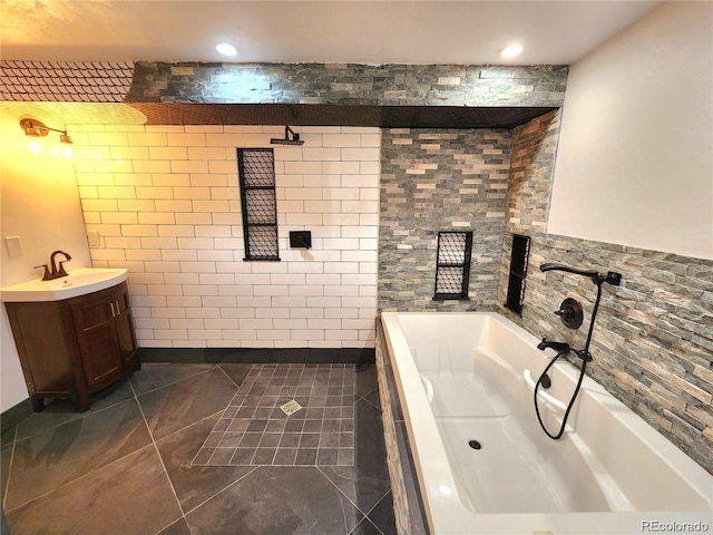 154 Fawn Ct, Silverthorne, CO 80443 - bathroom with a bath, vanity, tile patterned floors, tile walls, and recessed lighting