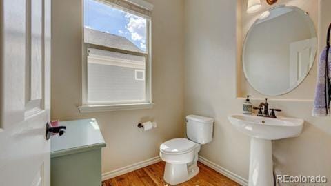 bathroom featuring hardwood / wood-style floors, toilet, and sink